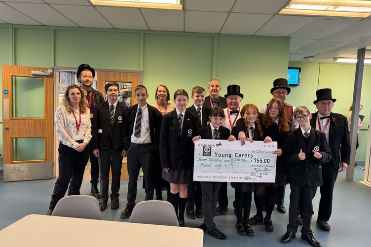 Bodmin College young carers being presented with the cheque by members of the Bodmin Wassail (Picture: Bodmin Wassail)